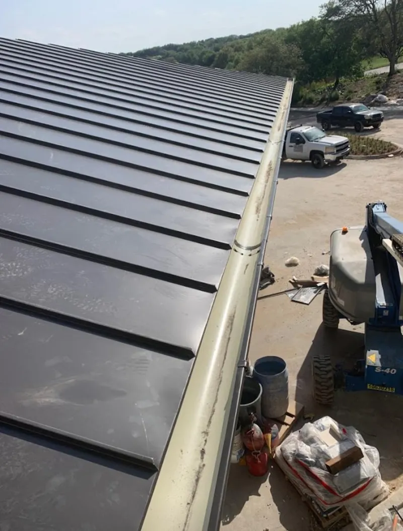 Standing seam panel and gutter detail on a metal roofing jobsite in Makawao